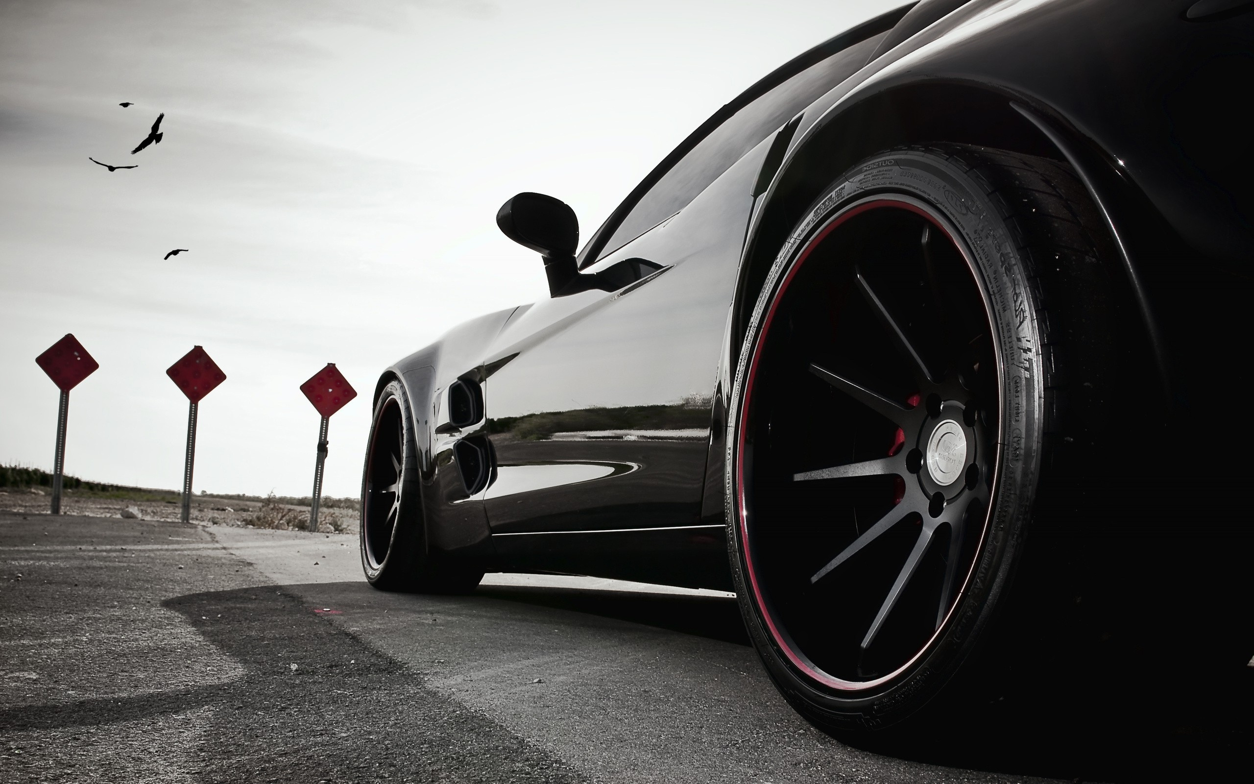 Black sports car with red wheel detail